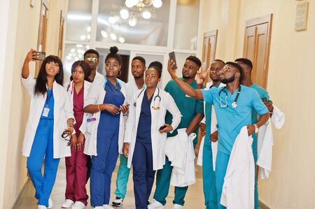 Group of african medical students in college making selfie together on phone.の写真素材