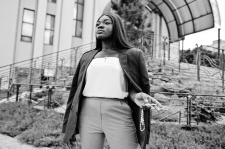 African american woman outdoor against church and prays to God. Concept for Faith, Spirituality and Religion.の写真素材