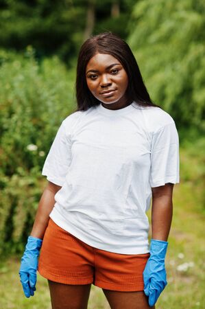 African volunteer woman in park. Africa volunteering, charity, people and ecology concept.