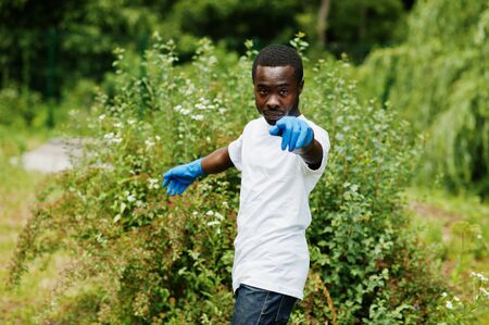 African volunteer man in park. Africa volunteering, charity, people and ecology concept.