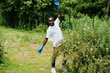 African volunteer man in park. Africa volunteering, charity, people and ecology concept.