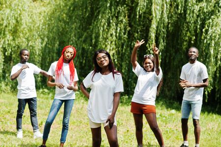 Group of african american peoples in park at white t-shirts.