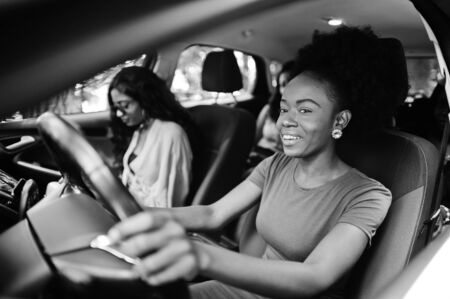 Group of african american girls friends having fun in the car.の写真素材