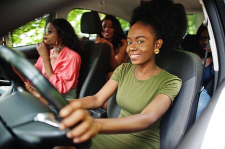 Group of african american girls friends having fun in the car.の写真素材