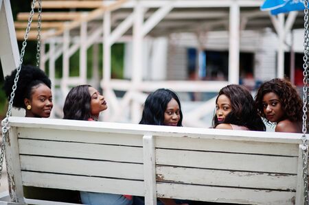 Group of five african american girls relaxing at beautiful swing.の写真素材