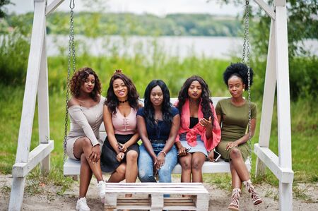 Group of five african american girls relaxing at beautiful swing.の写真素材