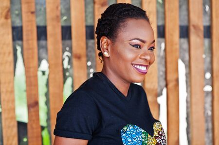 Young african american woman posed against wooden wall.の写真素材