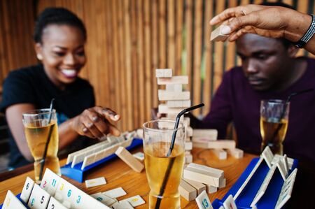 Group of three african american friends play table games.の写真素材