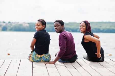 Three african american friends posed on pier.の写真素材