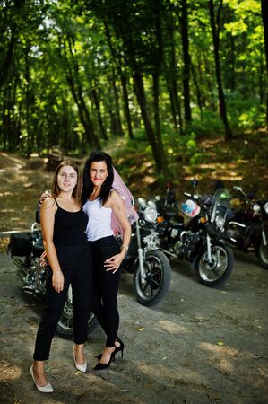 Ukraine, Tarnopol - September 8, 2018: Two young girls at hen party on choppers and wear black...