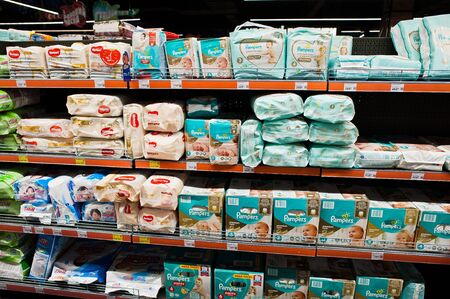 Kiev, Ukraine - September 4, 2019: Silpo supermarket. Pampers and other diapers on the shelf of store.のeditorial素材