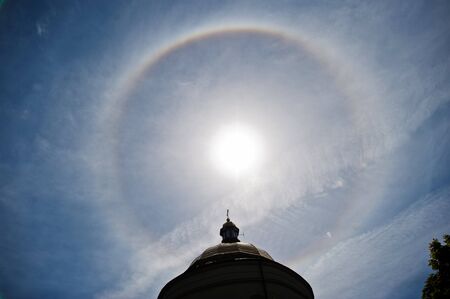 Fantastic beautiful sun halo phenomenon up the churchの写真素材