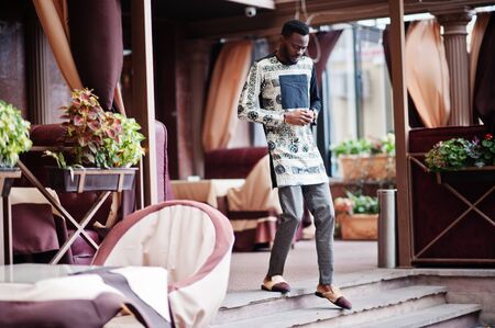 Handsome afro american man wearing traditional clothes in modern city.の写真素材
