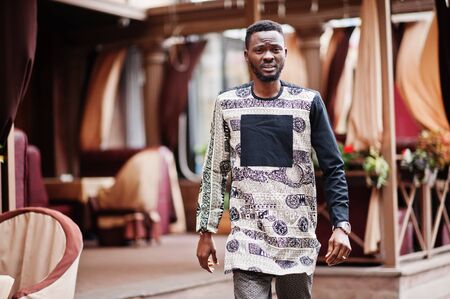 Handsome afro american man wearing traditional clothes in modern city.の写真素材