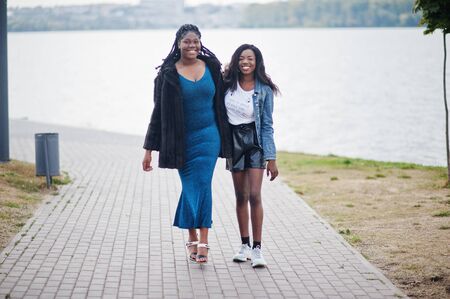 Two african american dark skinned friends female. One of them plus size model, second slim. Having fun and spending time together.の写真素材