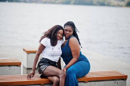 Two african american dark skinned friends female. One of them plus size model, second slim. Having fun and spending time together.の写真素材