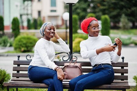Two young modern fashionable, attractive, tall and slim african muslim womans in hijab or turban...