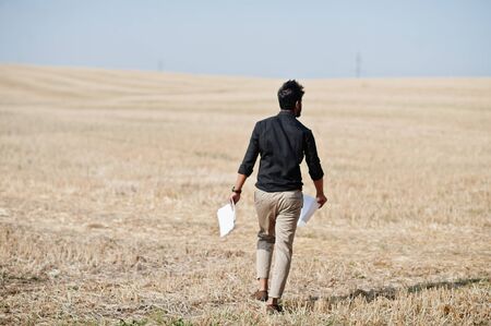South asian agronomist farmer threw the papers into the sky at wheat field. Agriculture production...