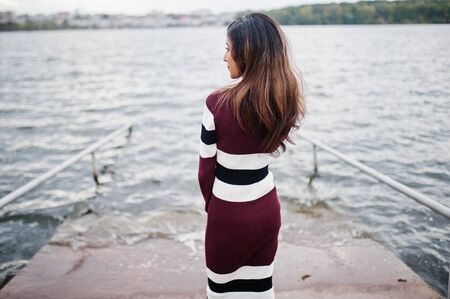 Back of young beautiful indian or south asian teenage girl in dress.の写真素材