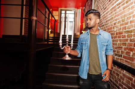 Portrait of handsome successful bearded south asian, young indian freelancer in blue jeans shirt...