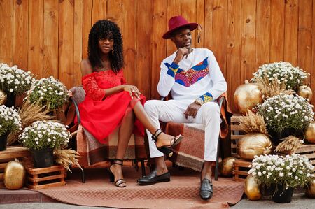 Stylish trendy afro france couple posed together at autumn day. Black african models in love sitting...