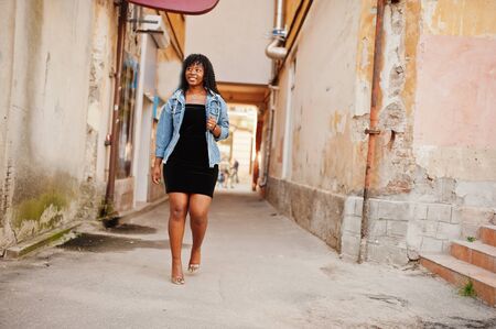 Stylish trendy afro france curly woman posed at autumn day in jeans jacket. Black african female model.の写真素材
