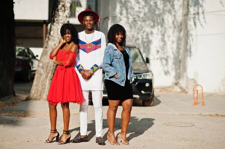 Group of three stylish trendy afro france friends posed at autumn day. Black african man model with two dark skinned womans.の写真素材