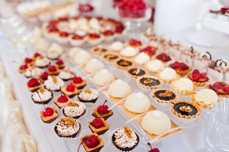 Dessert table of delicious sweets on wedding reception.