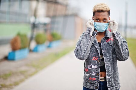 African girl at park wearing medical masks protect from infections and diseases coronavirus virus quarantine.の写真素材