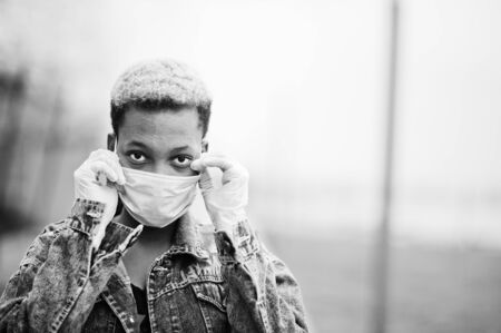 African girl at park wearing medical masks protect from infections and diseases coronavirus virus quarantine.の写真素材