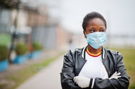African girl at park wearing medical masks protect from infections and diseases coronavirus virus quarantine.の写真素材
