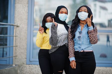 Group of three african american young volunteers wearing face mask outdoors.の写真素材