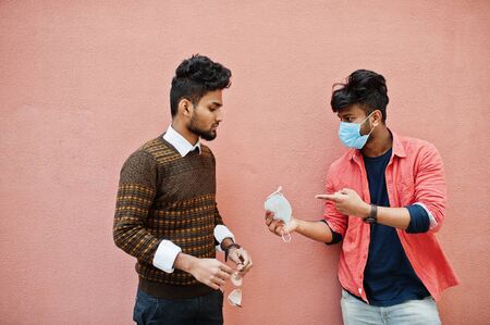 Coronavirus covid-19 concept. Two south asian indian man wearing mask for protect from corona virus...