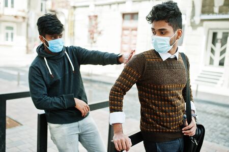 Coronavirus covid-19 concept. Two south asian indian man wearing mask for protect from corona virus. Social distance.の写真素材