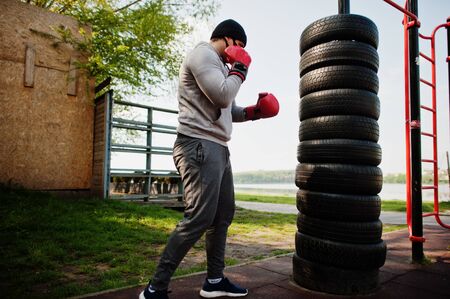 Portrait sports arabian boxer man in black medical face mask boxing outdoor during coronavirus quarantine.の写真素材