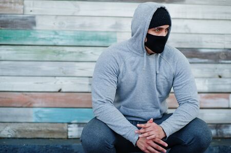 Portrait sports arabian man in black medical face mask and hoodie during coronavirus quarantine.の写真素材