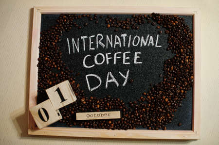 International coffe day words on blackboard flat lay.