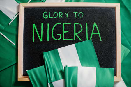 Glory to Nigeria. Text on board with nigerian flags.