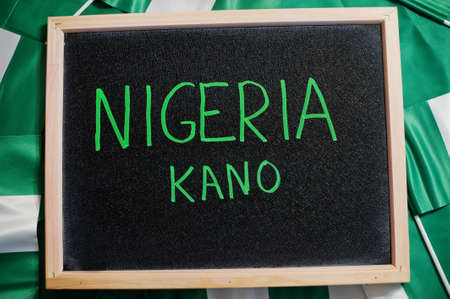 Happy independence day of Nigeria, Kano. Text on board with nigerian flags.の写真素材