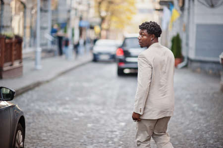 Stylish afro man in beige old school suit. Fashionable young African male in casual jacket on bare torso.の写真素材