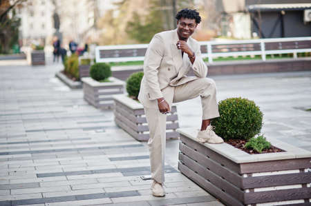Stylish afro man in beige old school suit. Fashionable young African male in casual jacket on bare torso.の写真素材