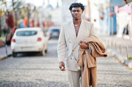Stylish afro man in beige old school suit. Fashionable young African male in casual jacket on bare torso.の写真素材
