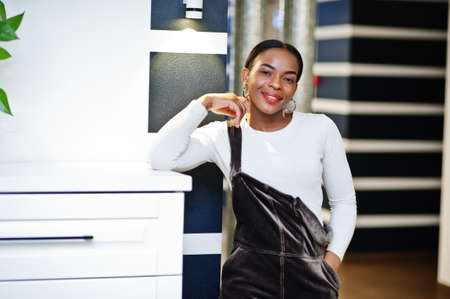 Charming african american woman posing at restaurant.