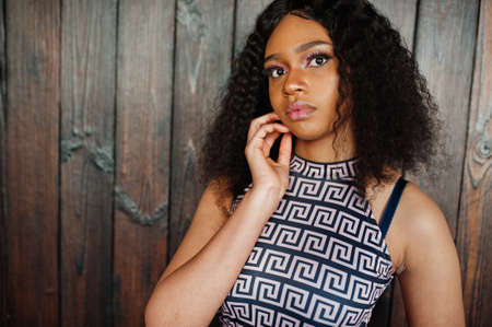 Close up portrait of charming elegant young african american woman with long curly hair.