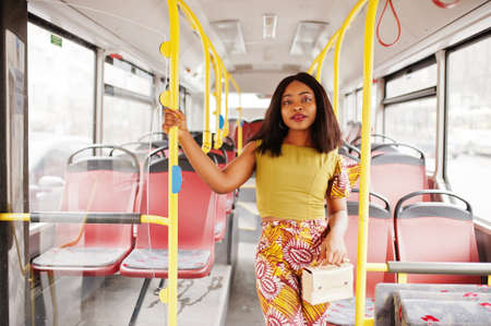 Young stylish african american woman riding on a bus.の写真素材