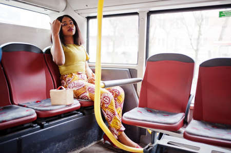 Young stylish african american woman riding on a bus.の写真素材