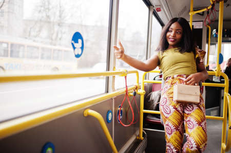 Young stylish african american woman riding on a bus.の写真素材