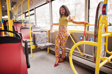Young stylish african american woman riding on a bus.