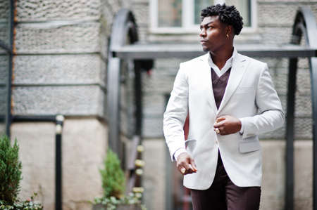 Thoughtful young handsome african american gentleman in formalwear. Black stylish model man in white...