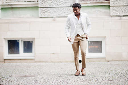 Thoughtful young handsome african american gentleman in formalwear. Black stylish model man in white jacket.の写真素材